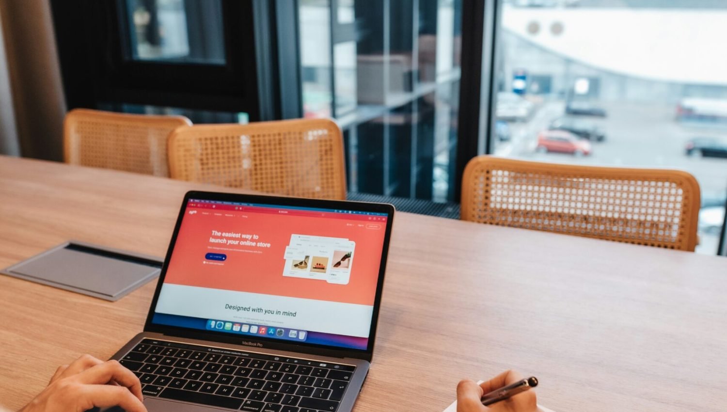 a person sitting at a table with a laptop